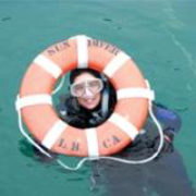 Diver looking through life buoy