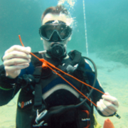 Diver ties knots at Cala Cortina